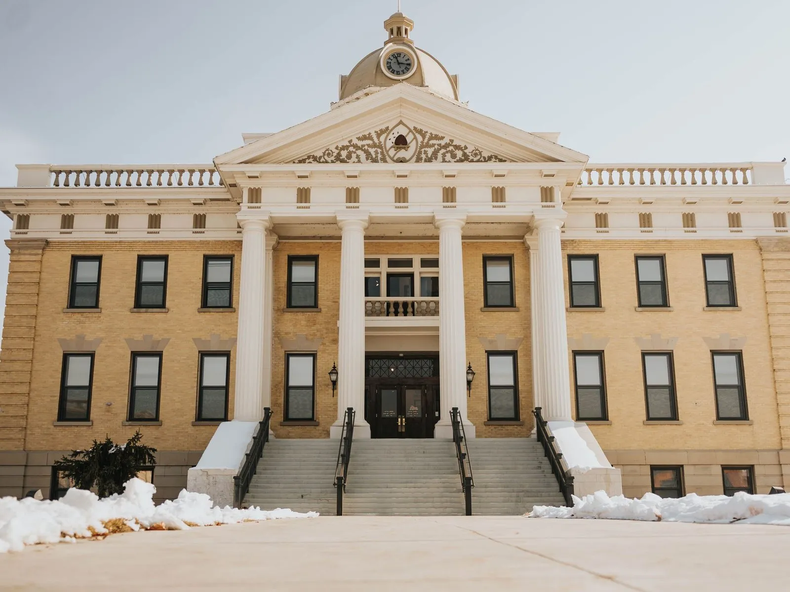 A county courthouse with white columns and wide front steps.