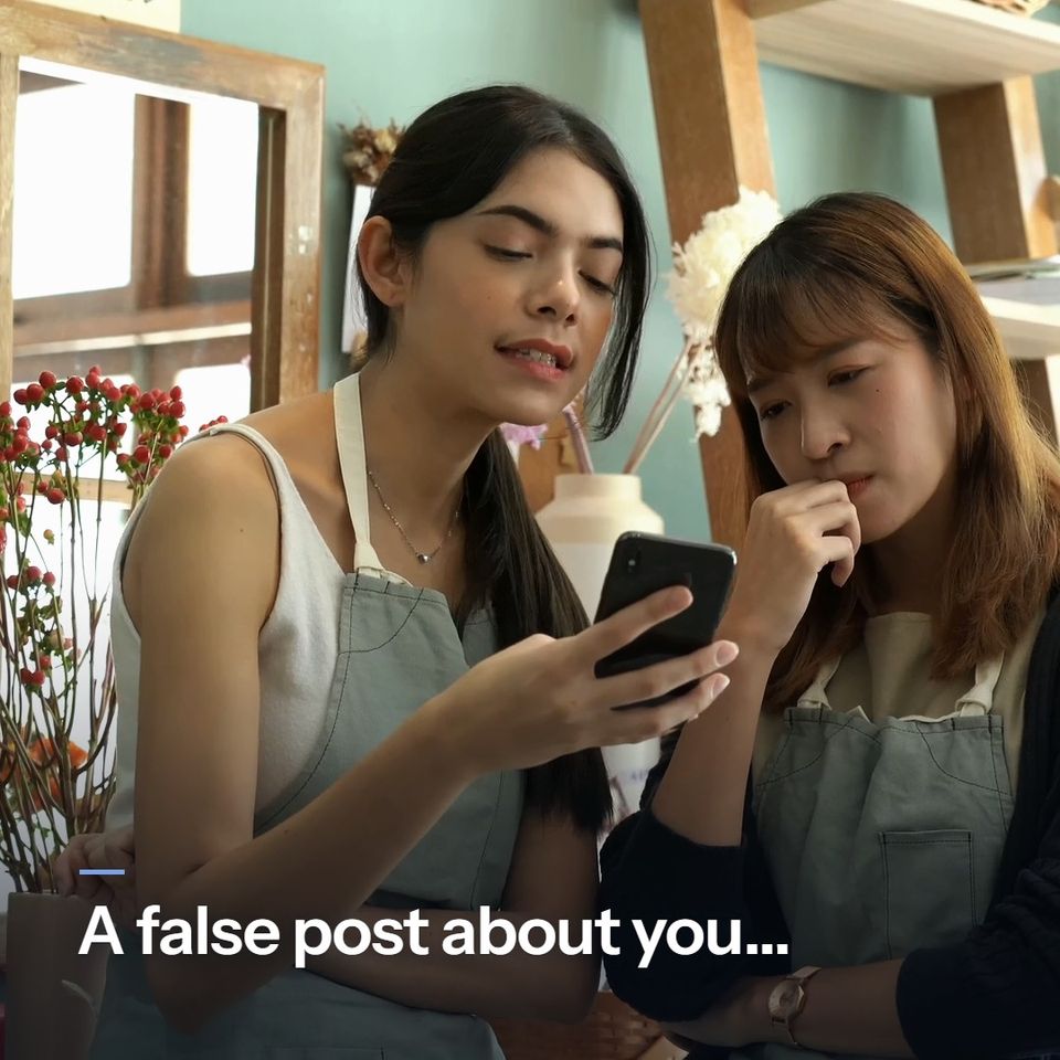 A short silent story. A florist is shown a post on a phone and her colleague puts a hand to her mouth: "A false post about you..." A couple read it together, dismayed: "...gets shared fast." The florist laughs on the phone: "We get posts that break the rules taken down." A customer leaves the shop with flowers: "Your name, cleared."