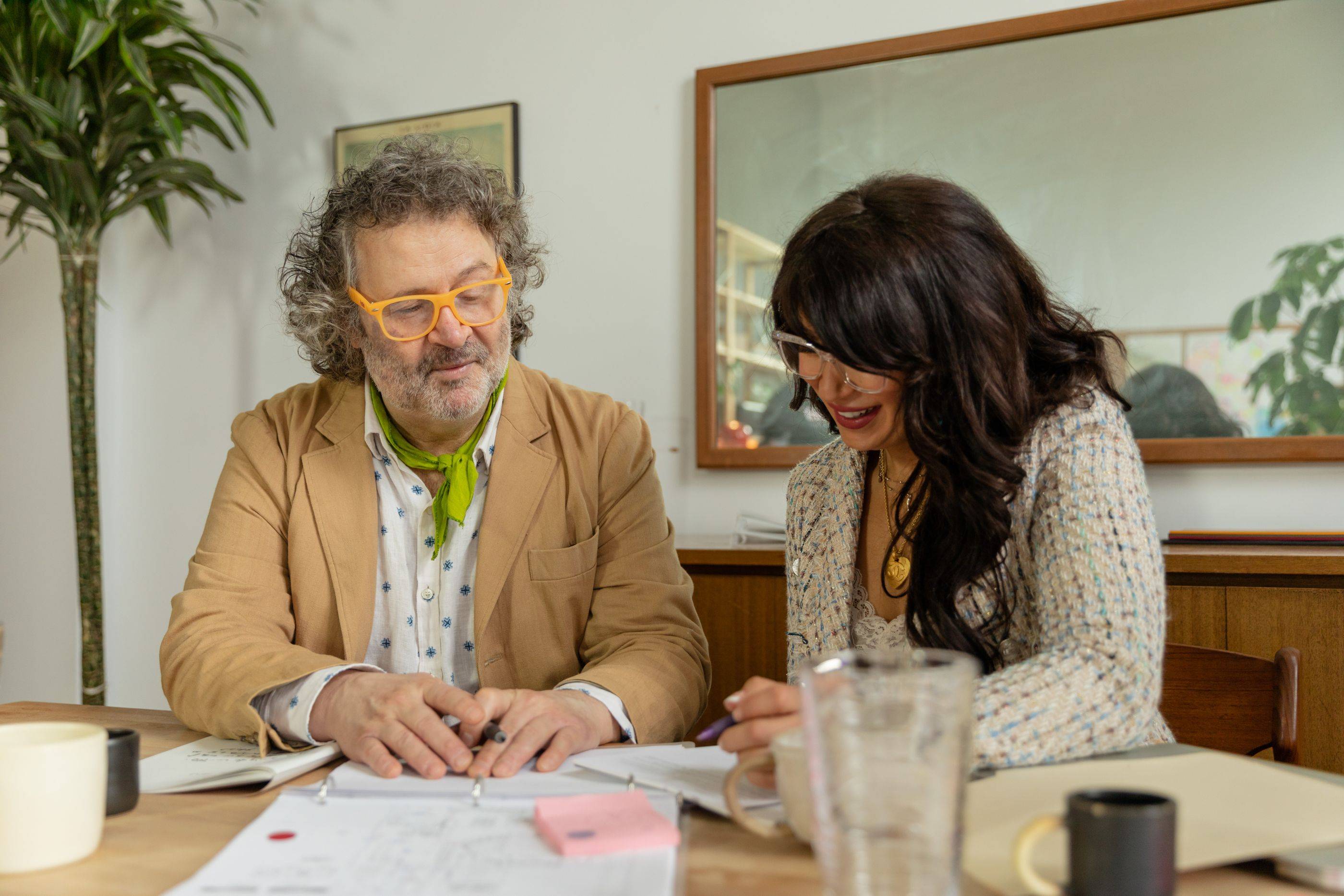 Two specialists go over their notes on a case at the desk